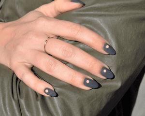 炭灰色的指甲上都有一个裸色的点。